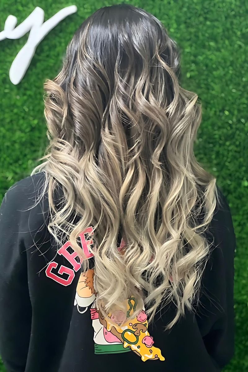 Highlighted wavy hair photographed at Hayat Signature